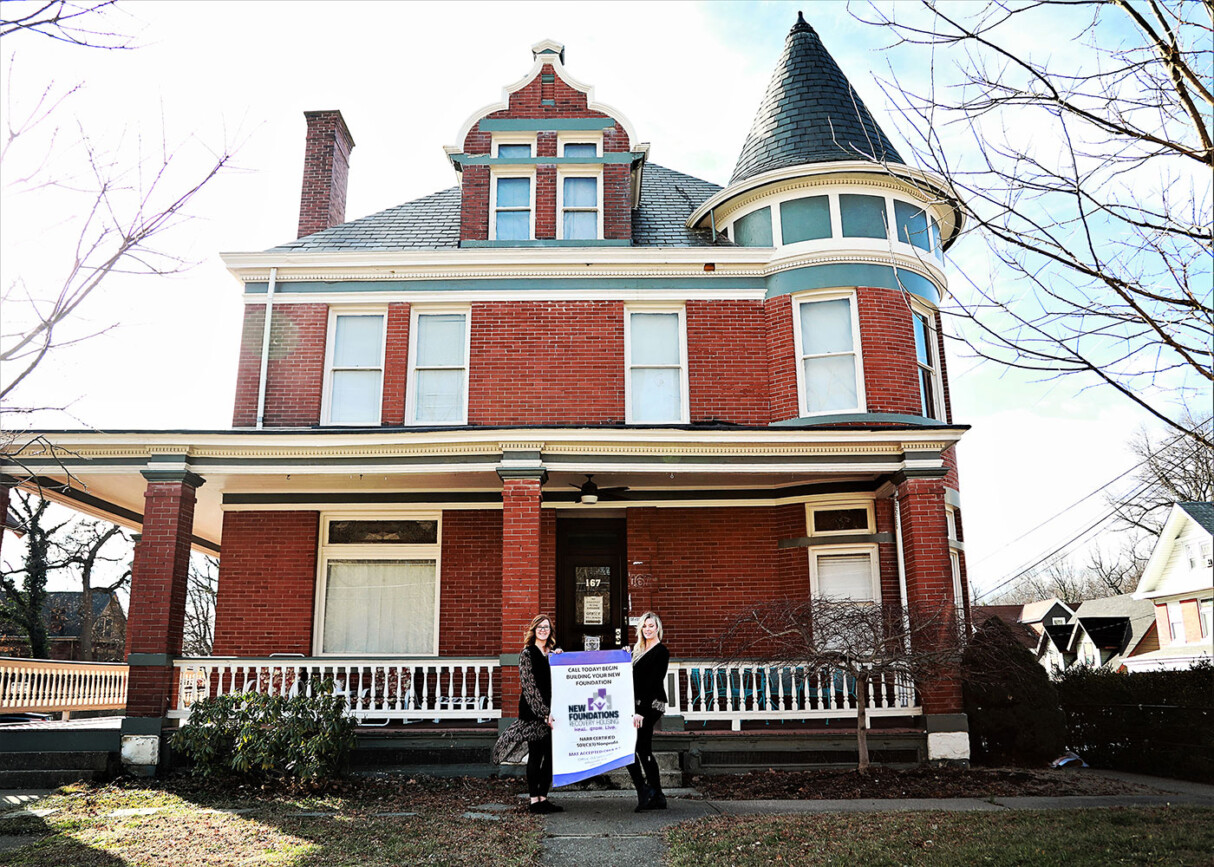 Large house with 2 women in front
